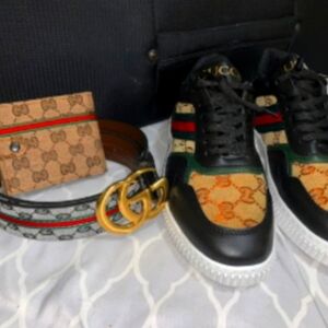 Pair of gucci loafers with a belt and wallet